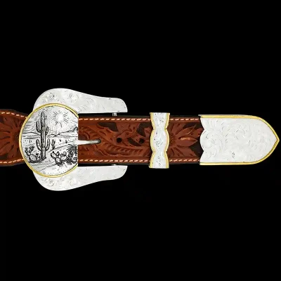 A custom western three piece belt buckle set featuring a silver plated base with a customizable western scene 